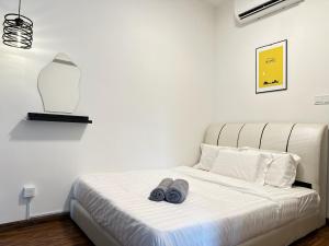 a bedroom with a bed with two slippers on it at KK City Homestay K Avenue BMG in Kota Kinabalu