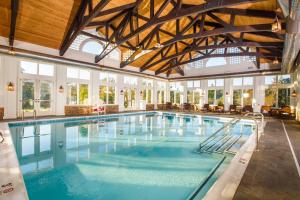 a large swimming pool with blue water in a building at Dollywood's DreamMore Resort and Spa in Pigeon Forge