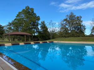 a swimming pool with a gazebo in the background at The Barracks, Tocal in Paterson