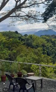 a table and two chairs sitting on a patio with a view at Casa Alto Bonito in Quimbaya +4 photos