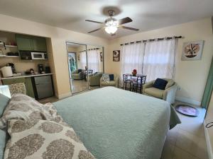 a bedroom with a bed and a living room at The Green Door Bungalow in Naples