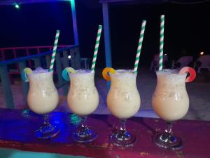 a group of three drinks with straws in them at Posada In the Caribbean in Providencia