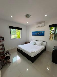 a bedroom with a bed and two windows at Relax private Pool Villas - 4 bedroom villas in Ao Nang Beach +54 photos