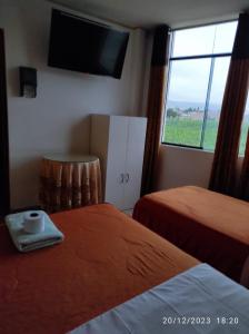 Postel nebo postele na pokoji v ubytování Hotel Pocollay