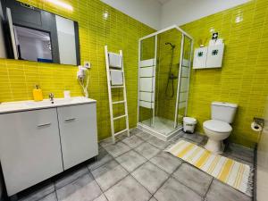 a yellow bathroom with a toilet and a shower at Douro sunset lounge in Porto +24 photos