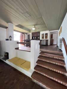 a living room with stairs and a dining room at Casas y Departamentos en Mina Clavero in Mina Clavero