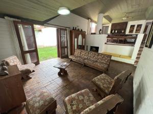 a living room with a couch and chairs and a table at Casas y Departamentos en Mina Clavero in Mina Clavero +7 photos