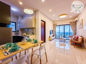 a kitchen and living room with a table and chairs at Danga Bay Country Garden by RR JBcity in Johor Bahru