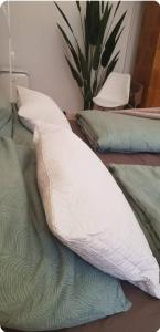 a white pillow sitting on top of a bed at Cozy flat near Kazinczy downtown in Budapest