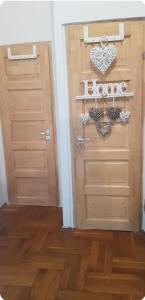 a room with two doors and a wooden floor at Cozy flat near Kazinczy downtown in Budapest +2 photos
