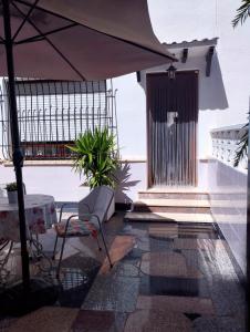 a patio with an umbrella and a table and chair at Casa Gares in Peñíscola