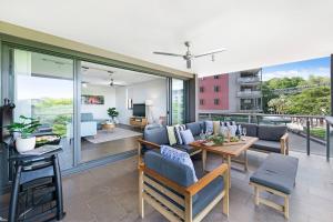 a living room with a couch and a table at Waterfront Bliss - Explore Darwin's Premier Location in Darwin
