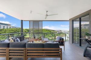 a living room with a couch and a large window at Waterfront Bliss - Explore Darwin's Premier Location in Darwin