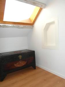 a attic room with a skylight and a wooden chest at River View Penthouse in Lisbon