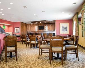 a dining room with wooden tables and chairs at Comfort Suites Greenwood in Greenwood