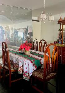 a dining room table with a christmas table cloth on it at Ponto do Paraíso - Quarto inteiro em apartamento compartilhado in Fortaleza +7 photos