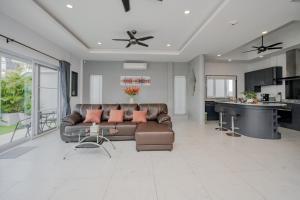 a living room with a couch and a table at Luxury 4 Bedroom Beach House in Ban Saiyuan (1)