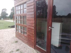 an open door to a building with a window at Tiny House en El Marquesado Playas del Sur de Mar del Plata in San Eduardo del Mar