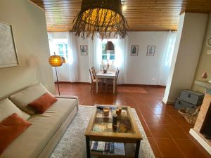 a living room with a couch and a table at Ribeira dos Caldeirões in Achada