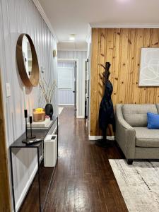 a living room with a couch and a mirror at Vernon Cozy 2BD Pet-Friendly Mountain Creek in Vernon +21 photos