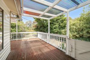a deck with a pergola on a house at Starry Nights in Cowes