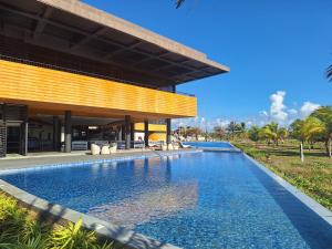 a swimming pool in front of a building at Seafront Residences Vacation Home in Batangas City