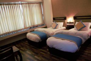 Postel nebo postele na pokoji v ubytování Hotel Tulip Pvt Ltd