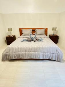 een slaapkamer met een groot bed met handdoeken erop bij Gatep Tree in Uluwatu