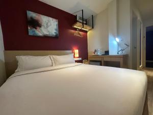 a bedroom with a large white bed in a room at SGI Vacation Club Hotel in Malacca