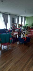 a living room with couches and tables in a room at Casa para ferias manizales in Manizales