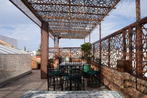 eine Terrasse mit Tisch und Stühlen in der Unterkunft Riad Asswar in Rabat