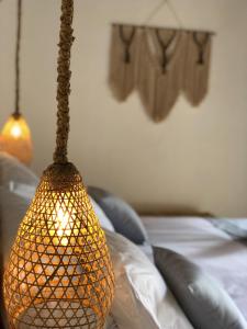 a lamp hanging over a bed in a room at AMAN Villas & SPA in Gili Islands +54 photos