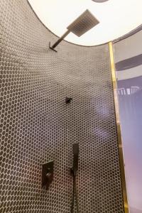 a bathroom with a clock on the wall at Cozylife Hotel Canal in Hangzhou