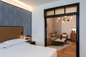 a bedroom with a bed and a living room at Sheraton Mall of the Emirates Hotel, Dubai in Dubai