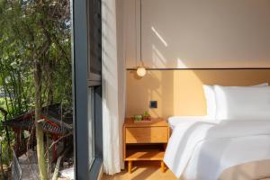 Postelja oz. postelje v sobi nastanitve Phoenix Ancient City Courtyard Hotel凤凰古城庭院酒店