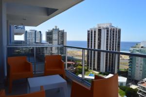 a balcony with a view of the ocean and buildings at Arenas del mar in Punta del Este