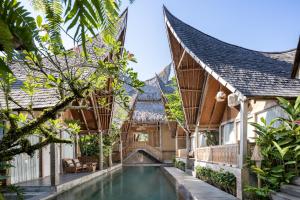 an external view of a house with a swimming pool at Premadhan Sanctuary in Canggu