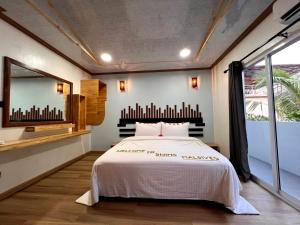 a bedroom with a bed and a large window at SWIMS Maldives in Omadhoo