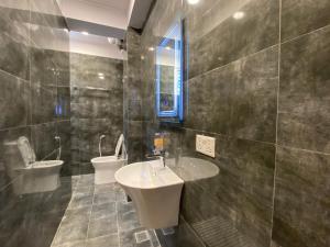 a bathroom with a sink and a toilet at Cozy French studio apartment with balcony in Kathmandu