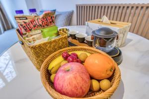 a basket of fruit sitting on a table at Cozylife Hotel Canal in Hangzhou