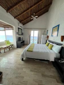 a bedroom with a large bed with a ceiling fan at “Magic Sunrise at Cancun” in Cancún