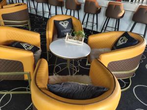 a group of chairs with a table in a room at Cozylife Hotel Canal in Hangzhou