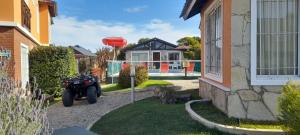 a motorcycle parked in the driveway of a house at Tonatiuh Casas de mar y spa in Mar Azul