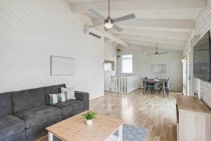 a living room with a couch and a table at Views on Esplanade I Skate Ramp I Sleeps 12! in Seaford