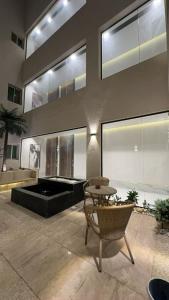 a large living room with a table and a pool at Cozy Stylish Apartment الياسمين شمال الرياض in Riyadh