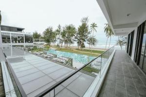 a view from the balcony of a house with a swimming pool at Roxy Beach Resort in Sematan