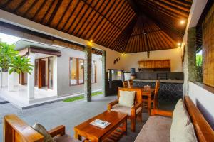 a living room with a couch and a table at Puri Arta Villa in Ubud