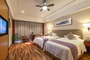 Luoxingge SSAW Boutiquel Hotel客房内的一张或多张床位