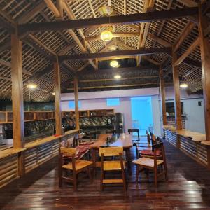 a dining room with a long table and chairs at Green Vietnam Farm Stay in Làng Trang