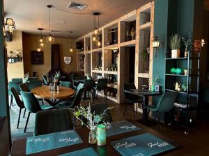 a restaurant with tables and chairs in a room at De Grenspost in Eijsden